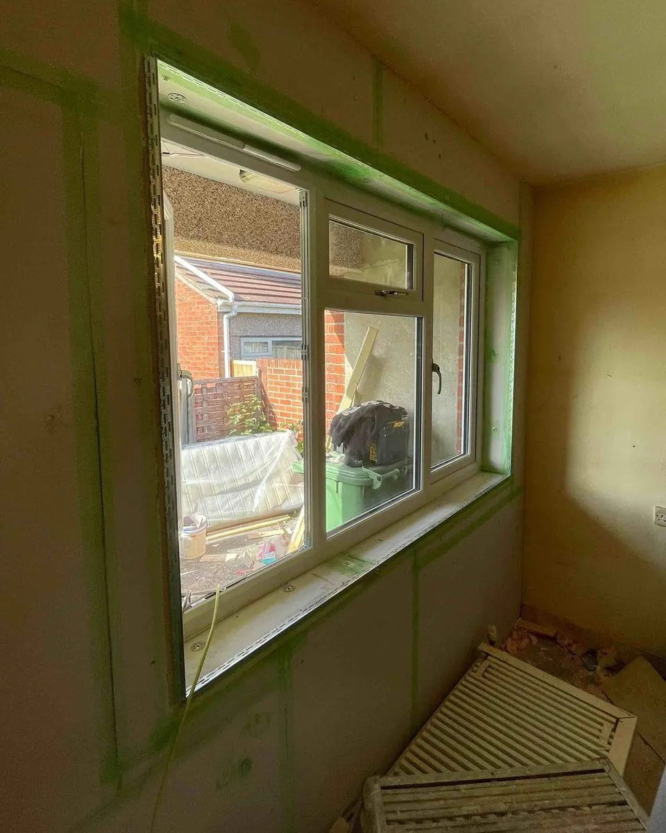 Kingspan Kooltherm K118 boards fixed to a bedroom wall, joints taped and the window reveal beaded ready for skim