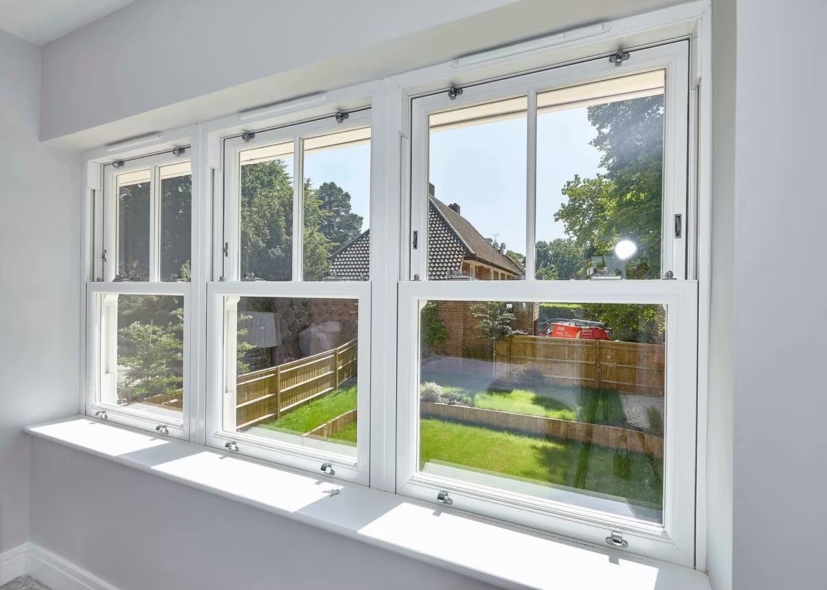 White uPVC sash windows looking out over a garden
