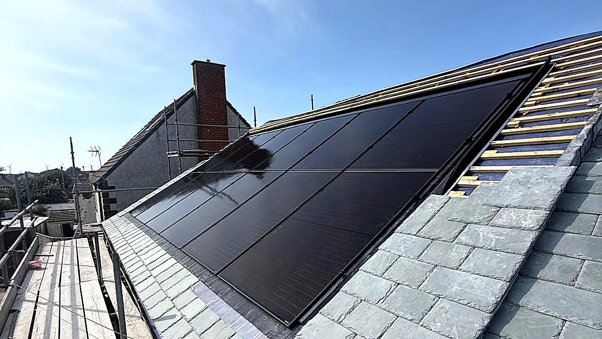 Black solar panels set flush into a new slate roof at The Rising Sun, Haverigg
