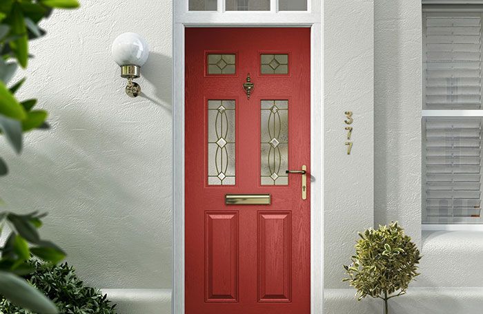 A red panelled composite door with brass fittings