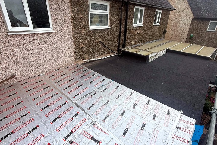 Insulation boards being laid over a flat roof by Energy Giants