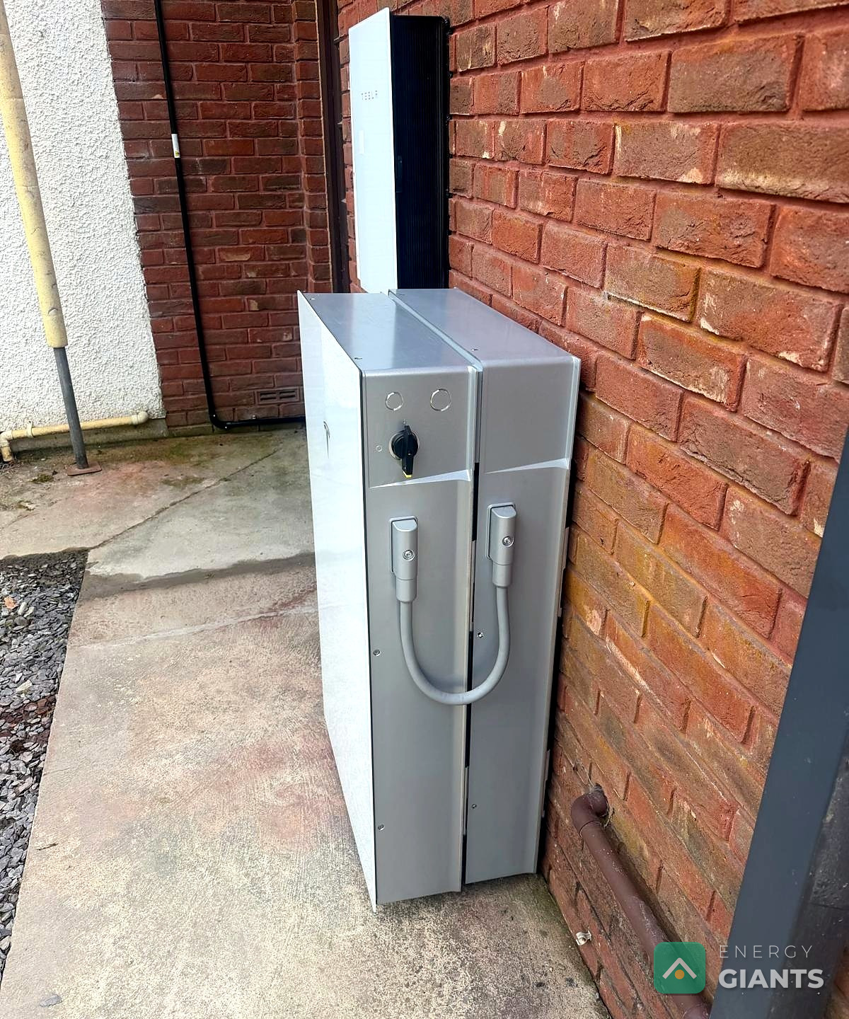 Tesla Powerwall 3 expansion unit mounted on the outside brick wall of a house near Aberystwyth, installed by Energy Giants
