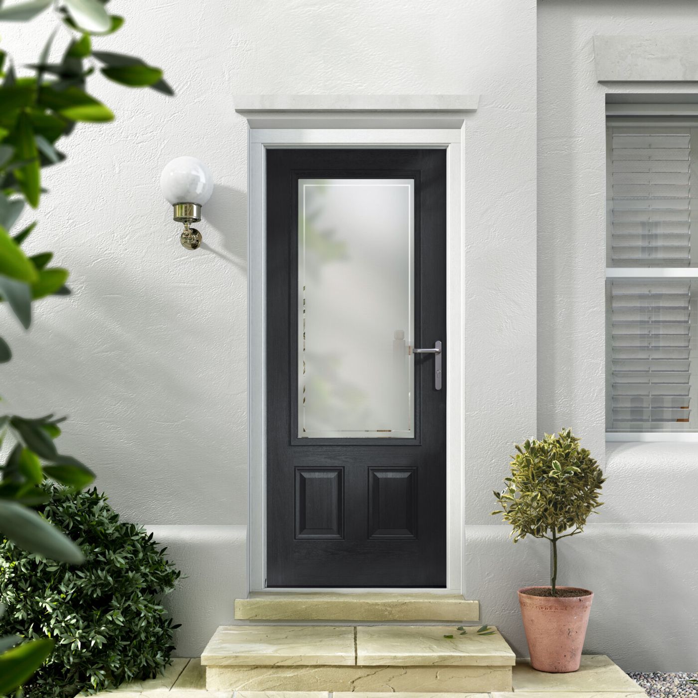 A black composite door with tall glass, framed by potted bay trees