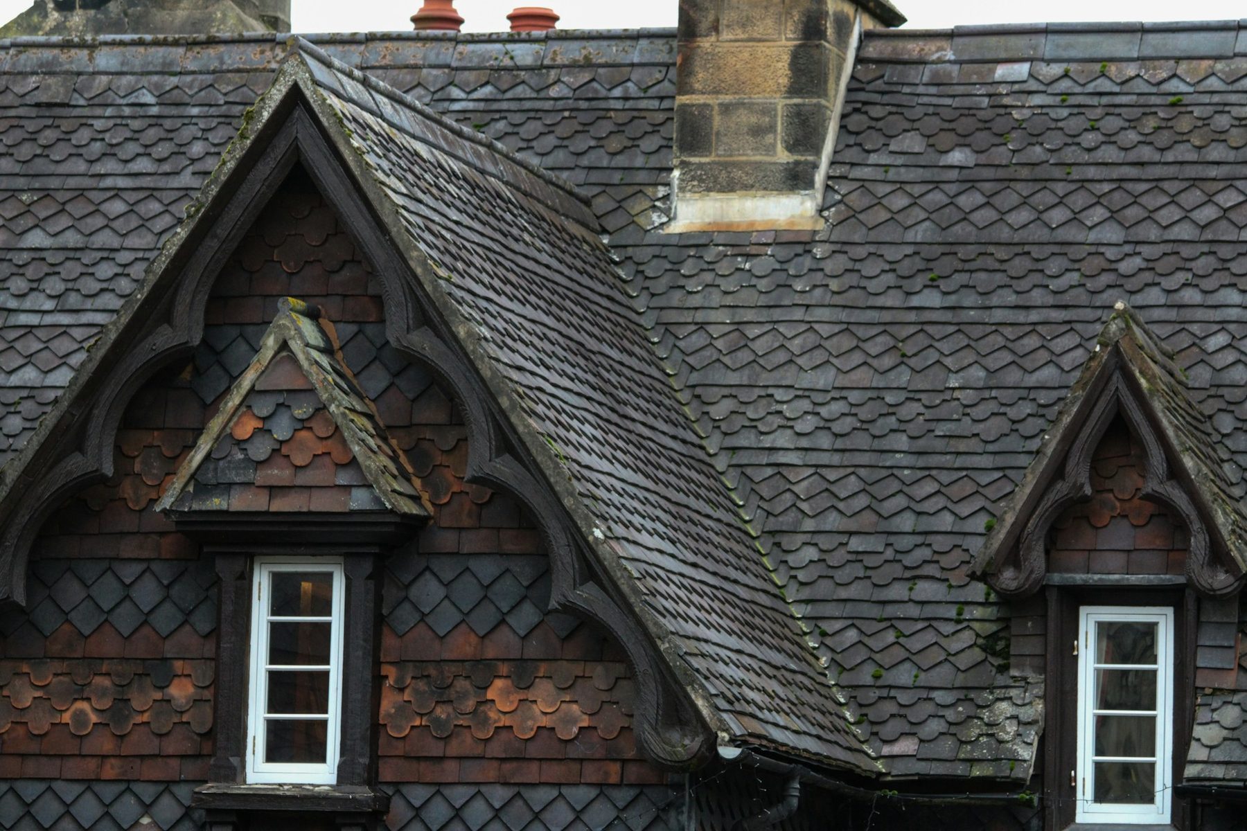 Gabled dormer windows set into a slate roof